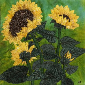 Sunflowers with green leaves on textured background.